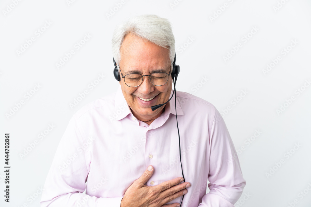 Telemarketer Middle age man working with a headset isolated on white background smiling a lot Telemarketer Middle age man working with a headset isolated on white background smiling a lot