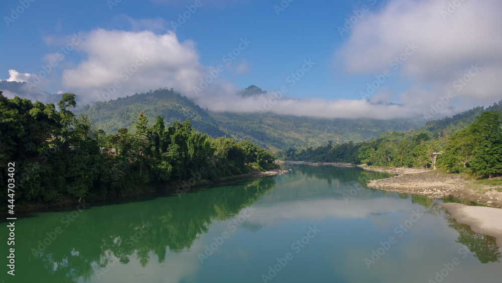 Scenic panorama view of the Subansiri river valley with mountain background and low morning clouds in Daporijo, Arunachal Pradesh, India