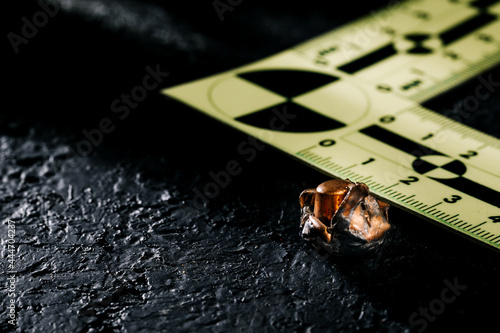 Evidence markers with a knife and a pistol magazine on the ground. A sign of an accident and murder at the scene of the crime. Police theme photo