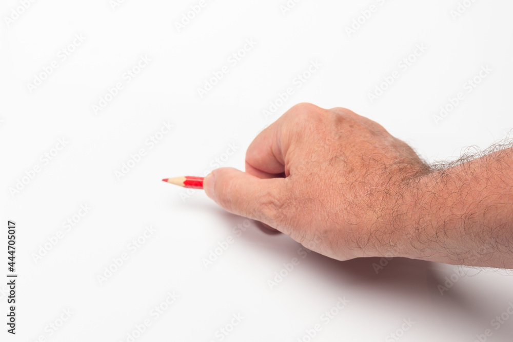 Coloured pencil in hand on white background Coloured pencil in hand on white background