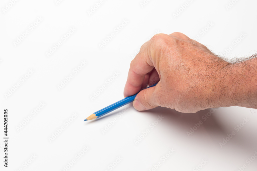Coloured pencil in hand on white background Coloured pencil in hand on white background