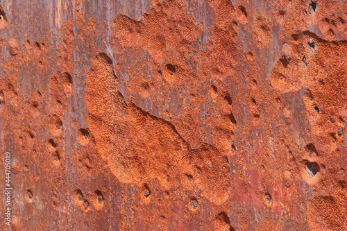 Abstract backgroundof close up pitted rusty metal surface photo