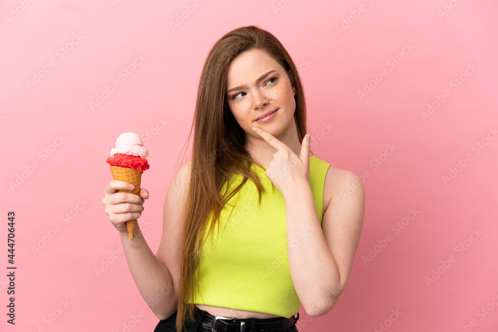 Teenager girl with a cornet ice cream over isolated pink background having doubts Teenager girl with a cornet ice cream over isolated pink background having doubts