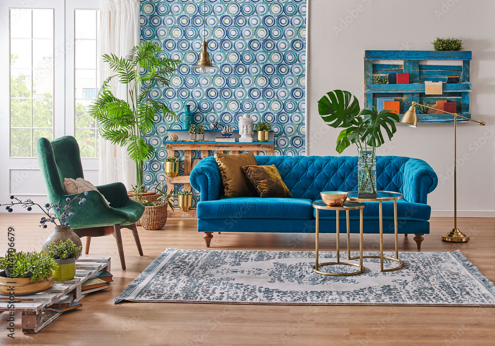 Blue wallpaper and sofa furniture style, decorative wooden palette bookshelf, gold lamp and middle table, vase of green plant, carpet and city view background. - obrazy, fototapety, plakaty 