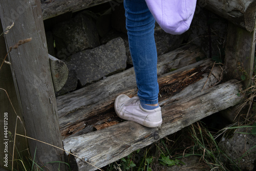 person climbing old wooden steps