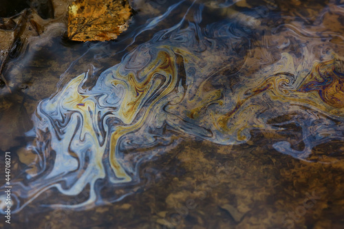 oil spills on puddle background  abstract gasoline nature pollution concept