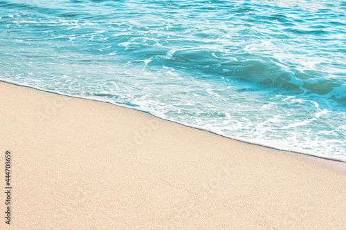 Soft blue ocean wave on sandy beach