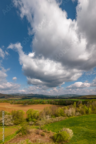 Landscape in Slovakia with Coal-fired Power Station in the background. Aerial view. Powerplant in Slovakia seen in distance surrounded by nature and small town.