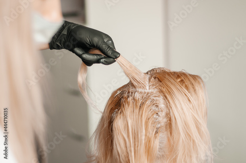 Hair coloring in a beauty salon in blonde. Hairdressing services