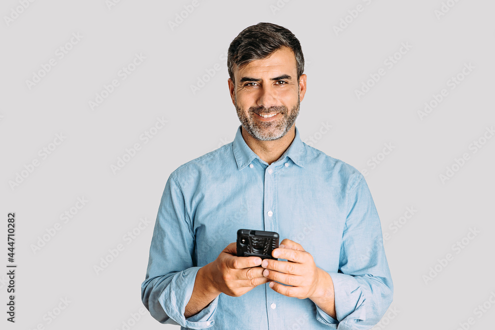 Man using smart phone and looking at camera on white background Man using smart phone and looking at camera on white background