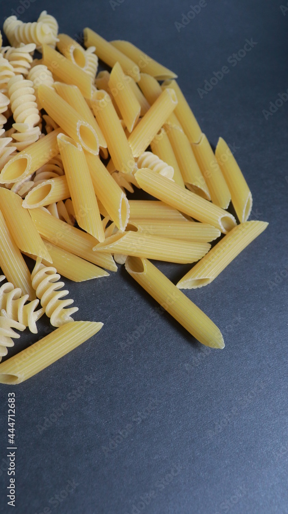 different noodles on black background different noodles on black background