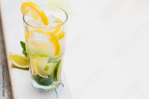 Homemade homemade lemonade. Space for text. Lemon, lime, mint and ice in a refreshing summer drink.