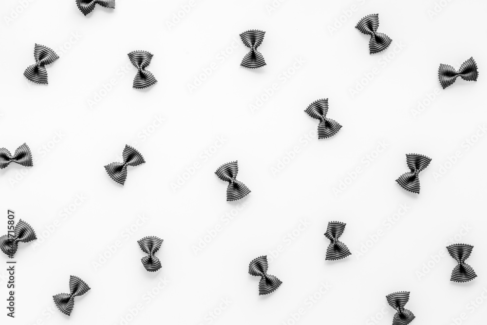 Naklejka premium Pasta pattern - colored farfalle, top view. Italian food background