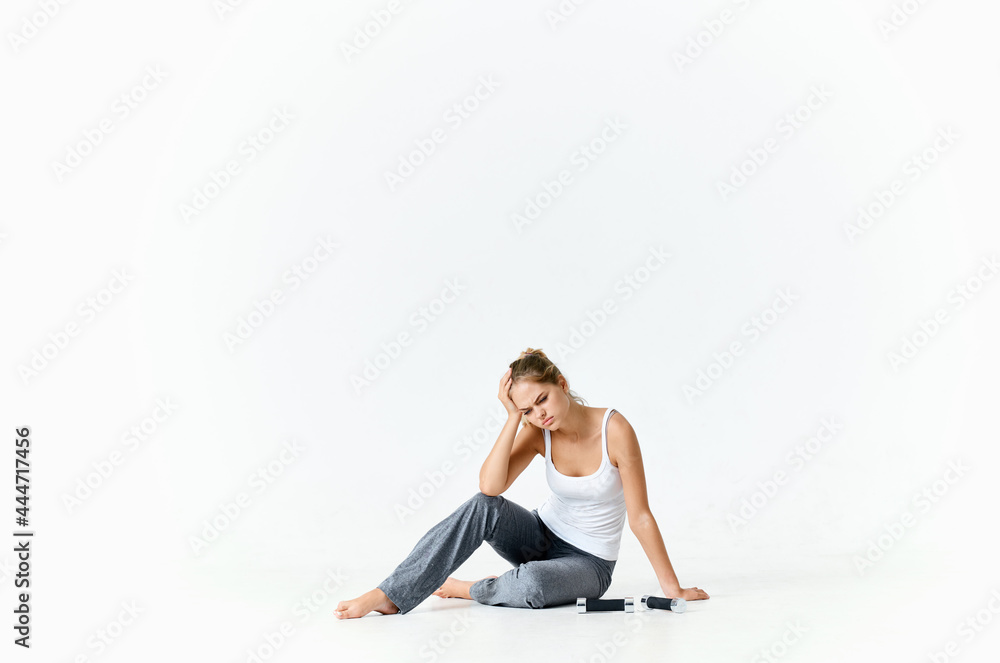 sportive woman sitting on the floor with dumbbells muscles training arms sportive woman sitting on the floor with dumbbells muscles training arms