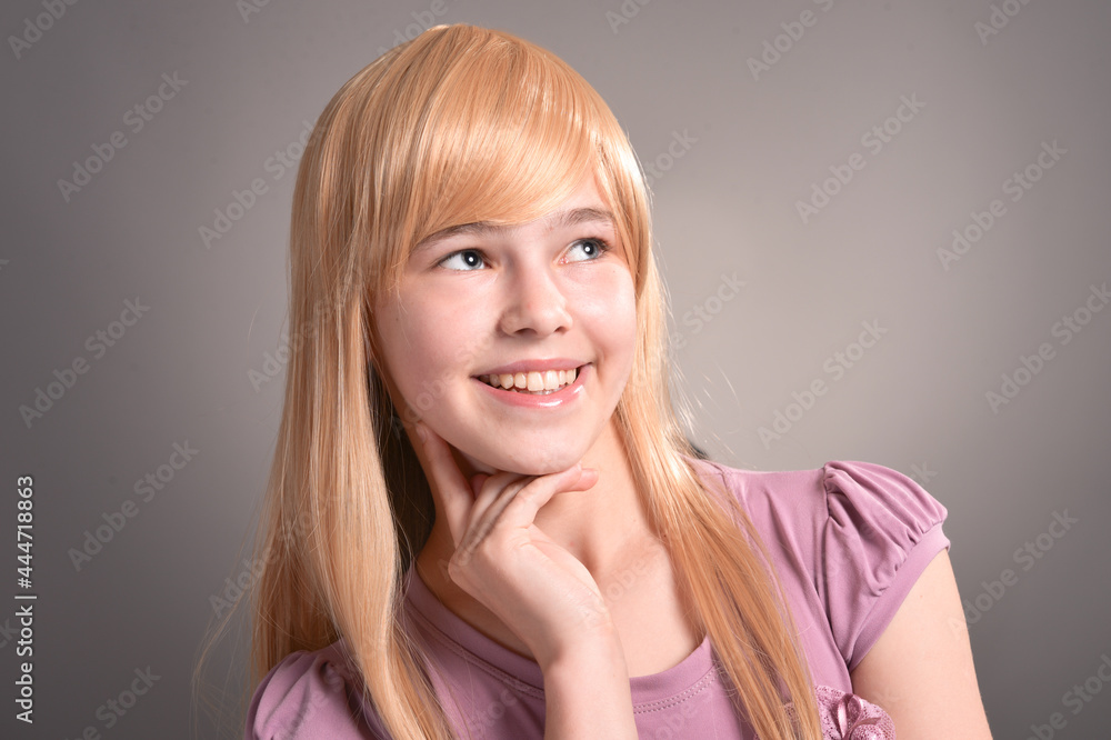 Fototapeta premium Beautiful girl posing in studio on background