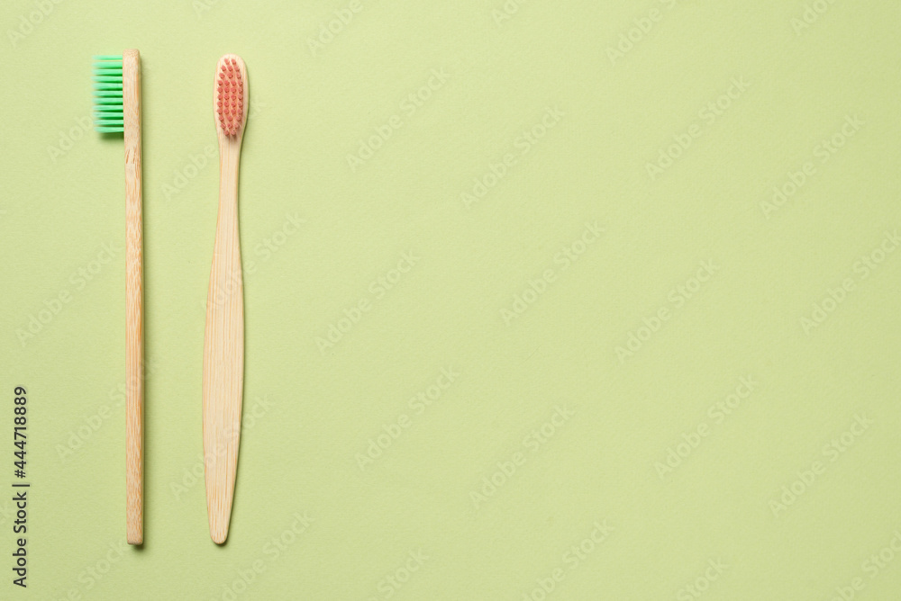 Bamboo toothbrush on a green background. Bamboo toothbrush on a green background.