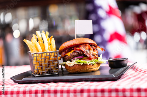 Burger with empty food flag and french fries in american restaurant.