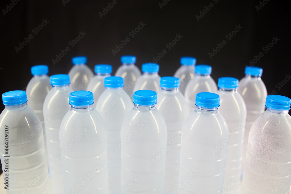 closeup Lots of bottle of water isolated on black closeup Lots of bottle of water isolated on black