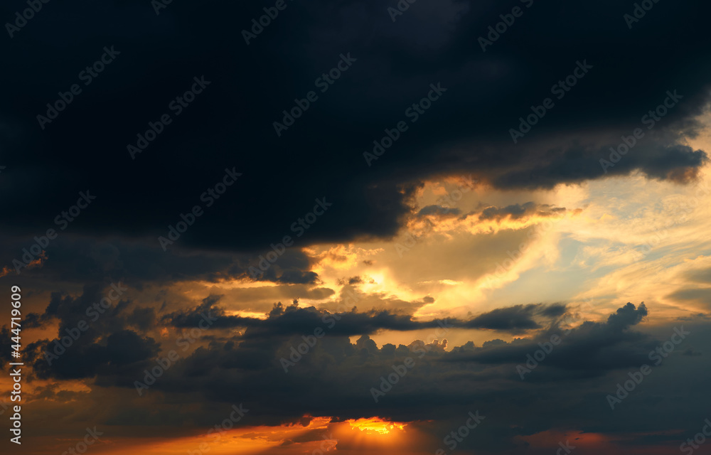 beautiful sunset sky, bright sun and dark silhouette of clouds as a background beautiful sunset sky, bright sun and dark silhouette of clouds as a background