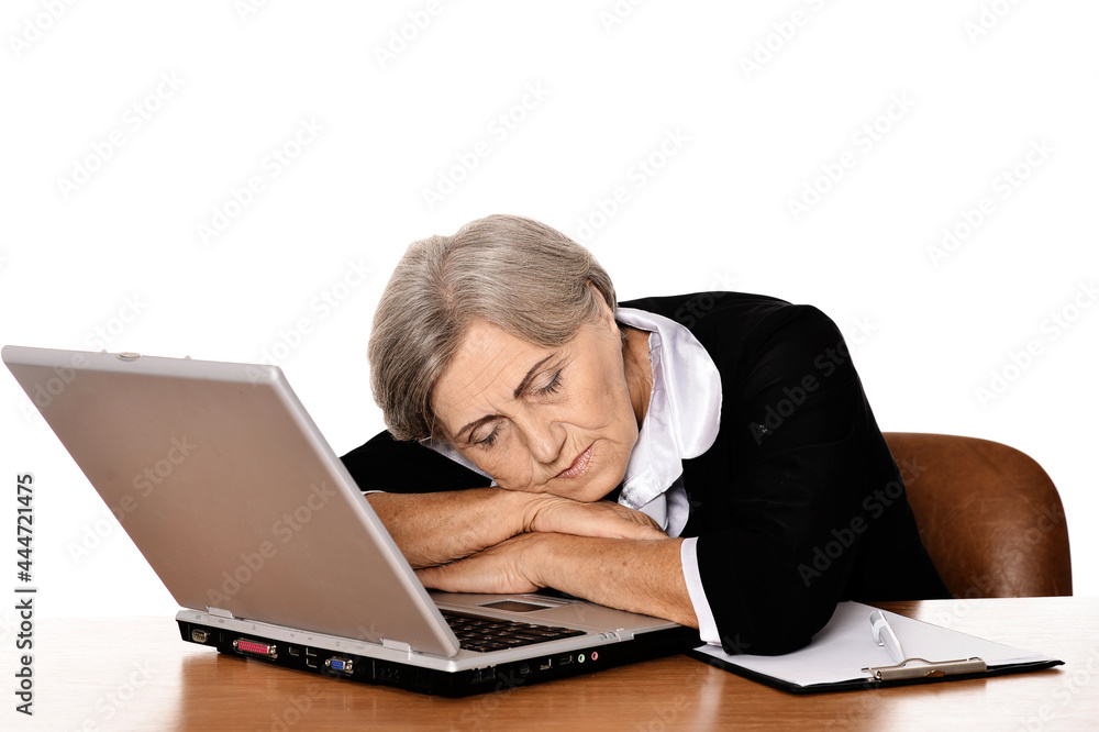 elderly woman sleeping at table with laptop elderly woman sleeping at table with laptop
