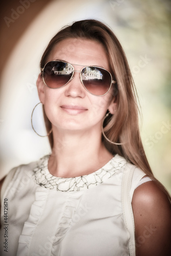 Young smiling woman in sunglasses