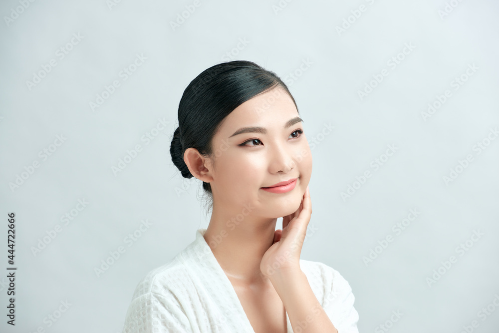 Beauty girl portrait. Young natural woman with clean face sitting at white table leaning on her elbows, over white background Beauty girl portrait. Young natural woman with clean face sitting at white table leaning on her elbows, over white background