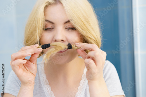 Woman making moustache braided hair © anetlanda