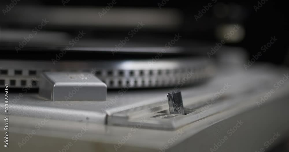 Turns on and off the power button of the turntable. Close-up. Turns on and off the power button of the turntable. Close-up.