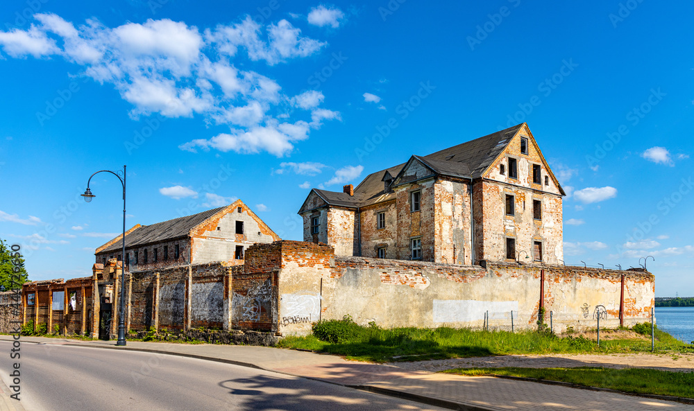 Fototapeta premium Ruins of historic Elk castle of Teutonic Order - Zamek w Elku - at Zamkowa street on shore of Jezioro Elckie lake in Masuria region of Poland