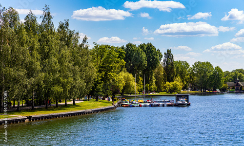 Fototapeta Naklejka Na Ścianę i Meble -  Panoramic view of Jezioro Elckie lake with shoreline touristic promenade and molo in Elk town of Masuria region in Poland