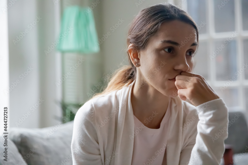 Close up of sad millennial Caucasian female look in distance think ponder of family divorce problems. Unhappy upset young woman distressed with troubles, suffer from miscarriage or abortion. Close up of sad millennial Caucasian female look in distance think ponder of family divorce problems. Unhappy upset young woman distressed with troubles, suffer from miscarriage or abortion.
