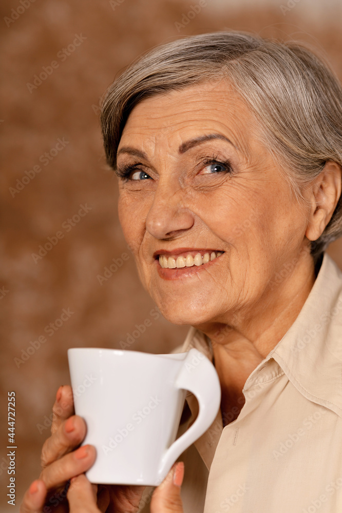 Close up portrait of beautiful smiling senior woman drinking tea Close up portrait of beautiful smiling senior woman drinking tea
