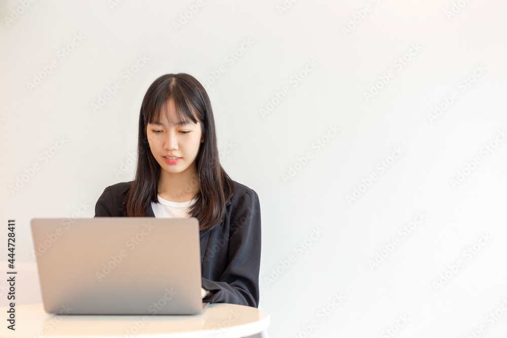 Asian woman using laptop on white background. Asian woman using laptop on white background.