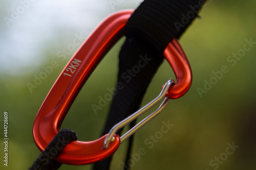 Installation of a hammock on slings and a carabin. Macro photo. Camping concept. photo