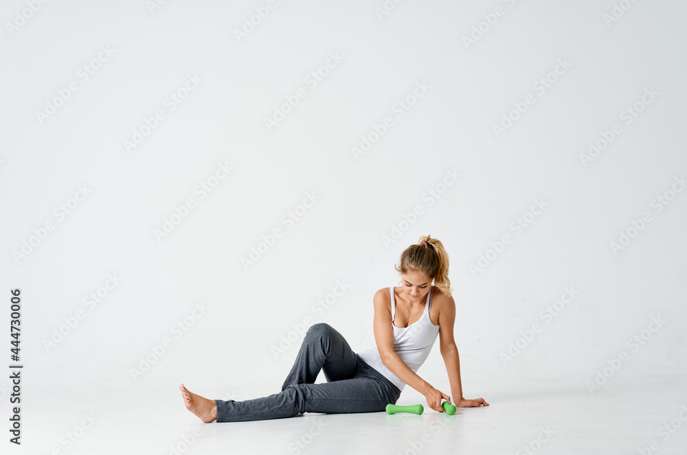 woman with dumbbells sitting on the floor exercise motivation workout woman with dumbbells sitting on the floor exercise motivation workout