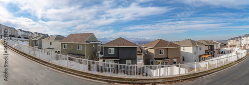 Two-storey houses with same style at Draper, Utah with a clear sky and mountain range background photo