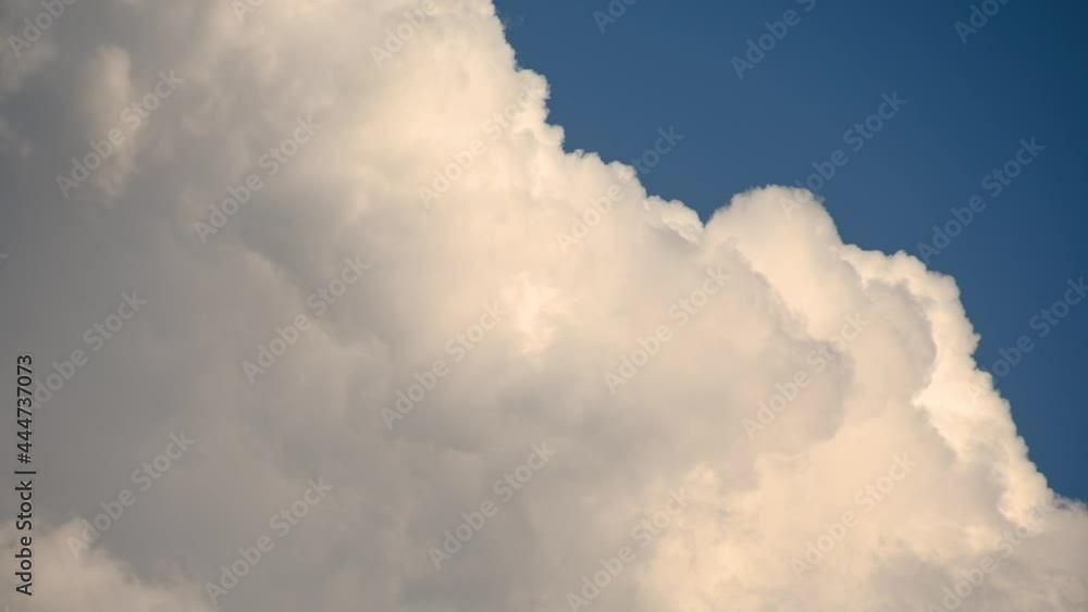 Close up view of white puffy fluffy white clouds against blue sky. Storm clouds forming. Cumulonimbus clouds. Real time Close up view of white puffy fluffy white clouds against blue sky. Storm clouds forming. Cumulonimbus clouds. Real time