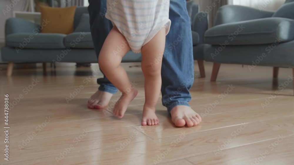 Close Up Father Holding And Helping His Little Baby Learning To Walk On Floor At Home
Close Up Father Holding And Helping His Little Baby Learning To Walk On Floor At Home
