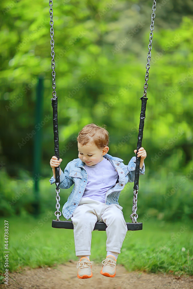 springtime, a boy in the spring swinging on a swing, leisure enjoyment childhood summer happy child springtime, a boy in the spring swinging on a swing, leisure enjoyment childhood summer happy child