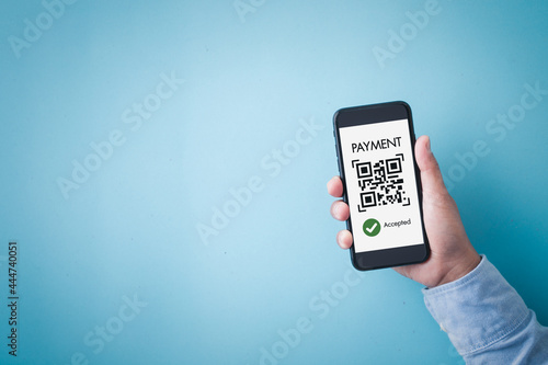 Hand holding smartphone sceen with application online payment, moblie phone business shopping online and blue background.