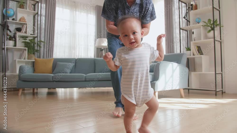 Father Encouraging Smiling Baby Son To Take First Steps And Walk At Home
Father Encouraging Smiling Baby Son To Take First Steps And Walk At Home