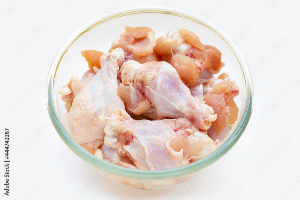 Fresh raw chicken wings (wingstick) in glass bowl on white background. Fresh raw chicken wings (wingstick) in glass bowl on white background.