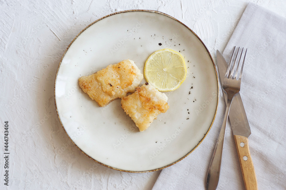 Fried fish with lemon. Minimalism Fried fish with lemon. Minimalism