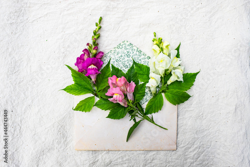 Vintage envelope with colorful flowers on a white background for celebration design.