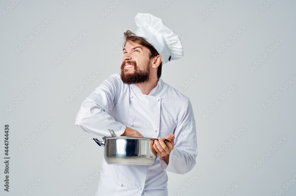male chef preparing food in a saucepan kitchen professional male chef preparing food in a saucepan kitchen professional