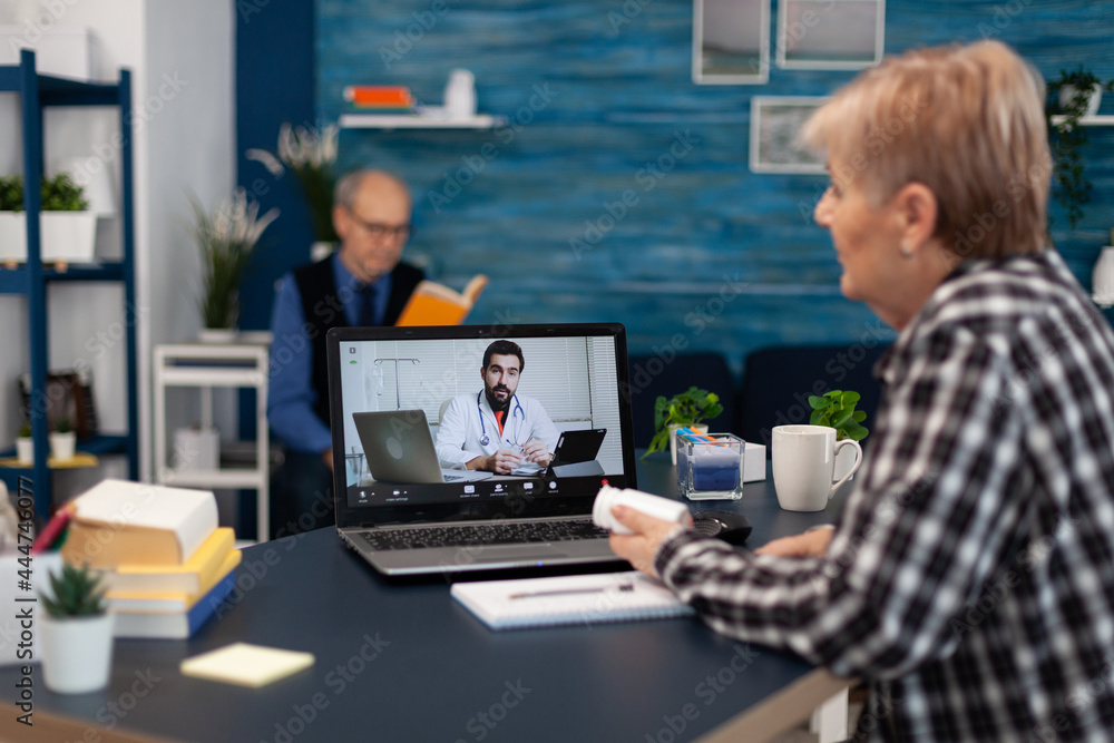 Sick senior woman talking with young doctor during remote consultation. Elderly telemedicine online conference call with practitioner doctor using modern healthcare technology, web diagnosis Sick senior woman talking with young doctor during remote consultation. Elderly telemedicine online conference call with practitioner doctor using modern healthcare technology, web diagnosis