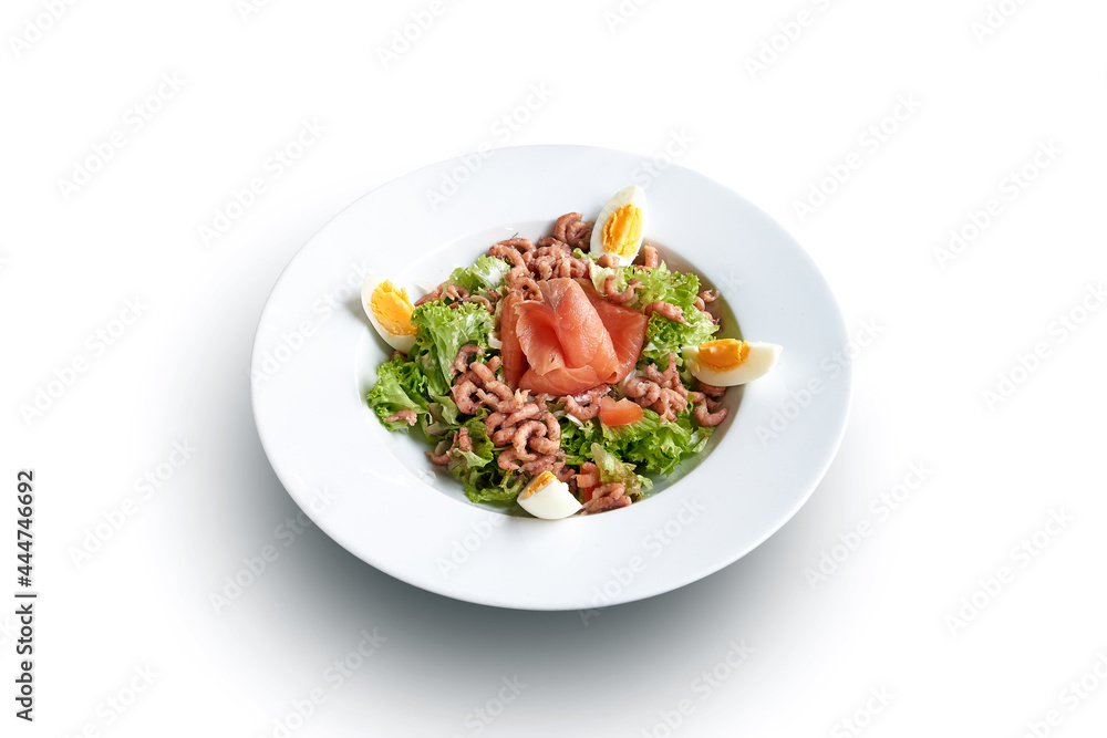 White plate with shrimps and salmon on salad isolated White plate with shrimps and salmon on salad isolated