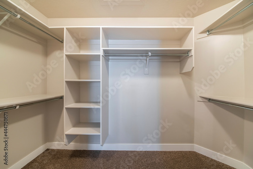 Interior of a small walk-in closet with carpeted floor