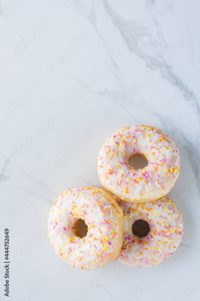 Donuts on white marble surface. Photo flat lay, top view. Donuts on white marble surface. Photo flat lay, top view.