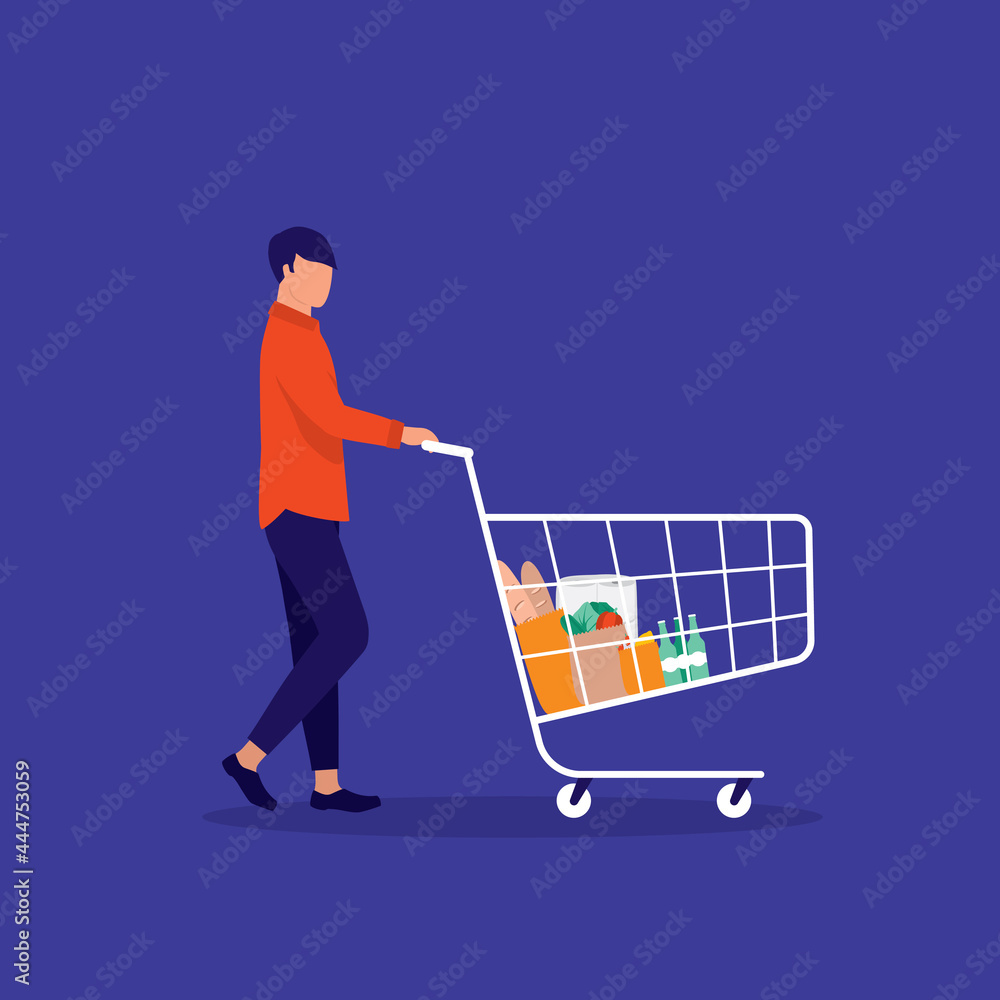 Side View Of A Young Male Customer Pushing Shopping Cart With Groceries Item Inside. E-Commerce. Side View Of A Young Male Customer Pushing Shopping Cart With Groceries Item Inside. E-Commerce.